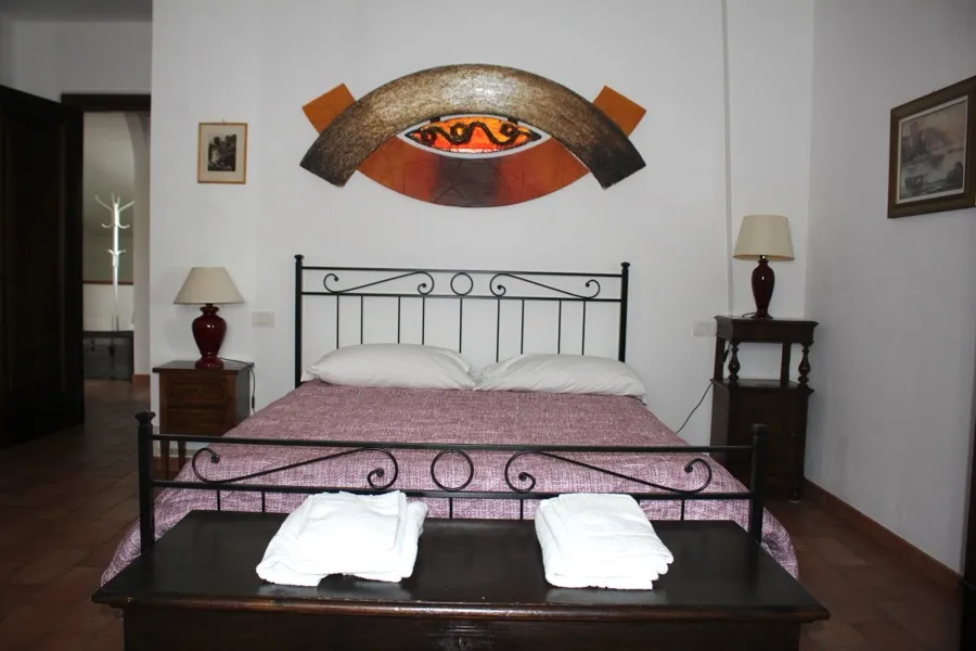 Camera Marte — letto ferro battuto con opera d'arte copper